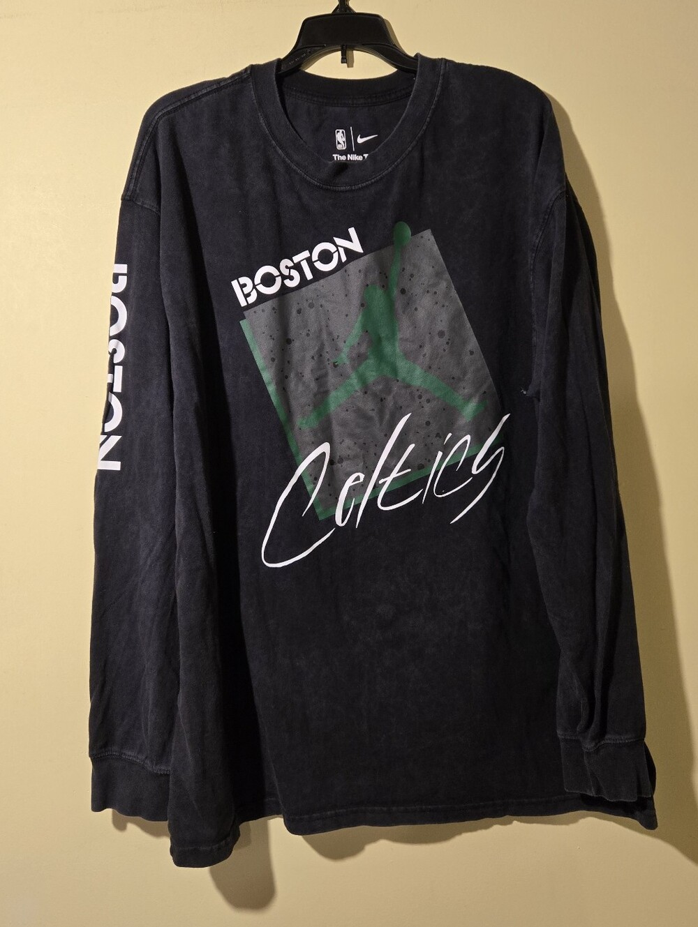 Men"s Nike Boston Celtics Black Long-Sleeve Graphic Shirt.
